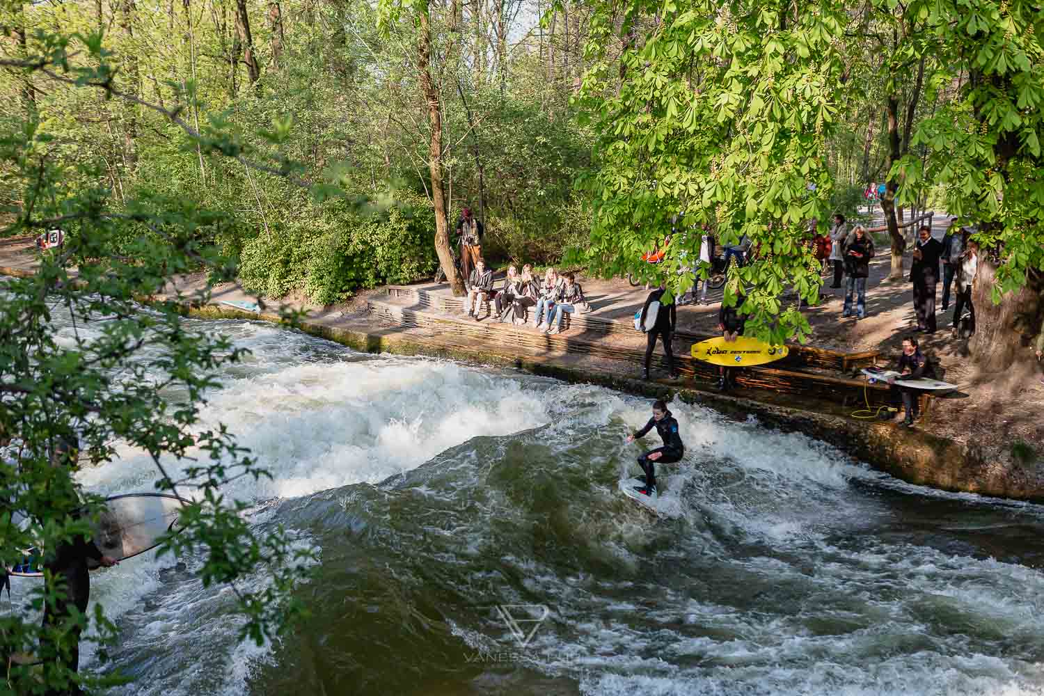 Eisbachwelle Munich - Surfing in the Eisbach - Canon advertising shoot - Surfing on the Eisbach Munich - Come and See - Canon commercial shoot - Tao, Karina, Alex - Samo Vidic - Campaign Fall 2016 - Autumn/Winter 16/17 - Surfing on the Eisbach, Munich, Prinzregentenstraße