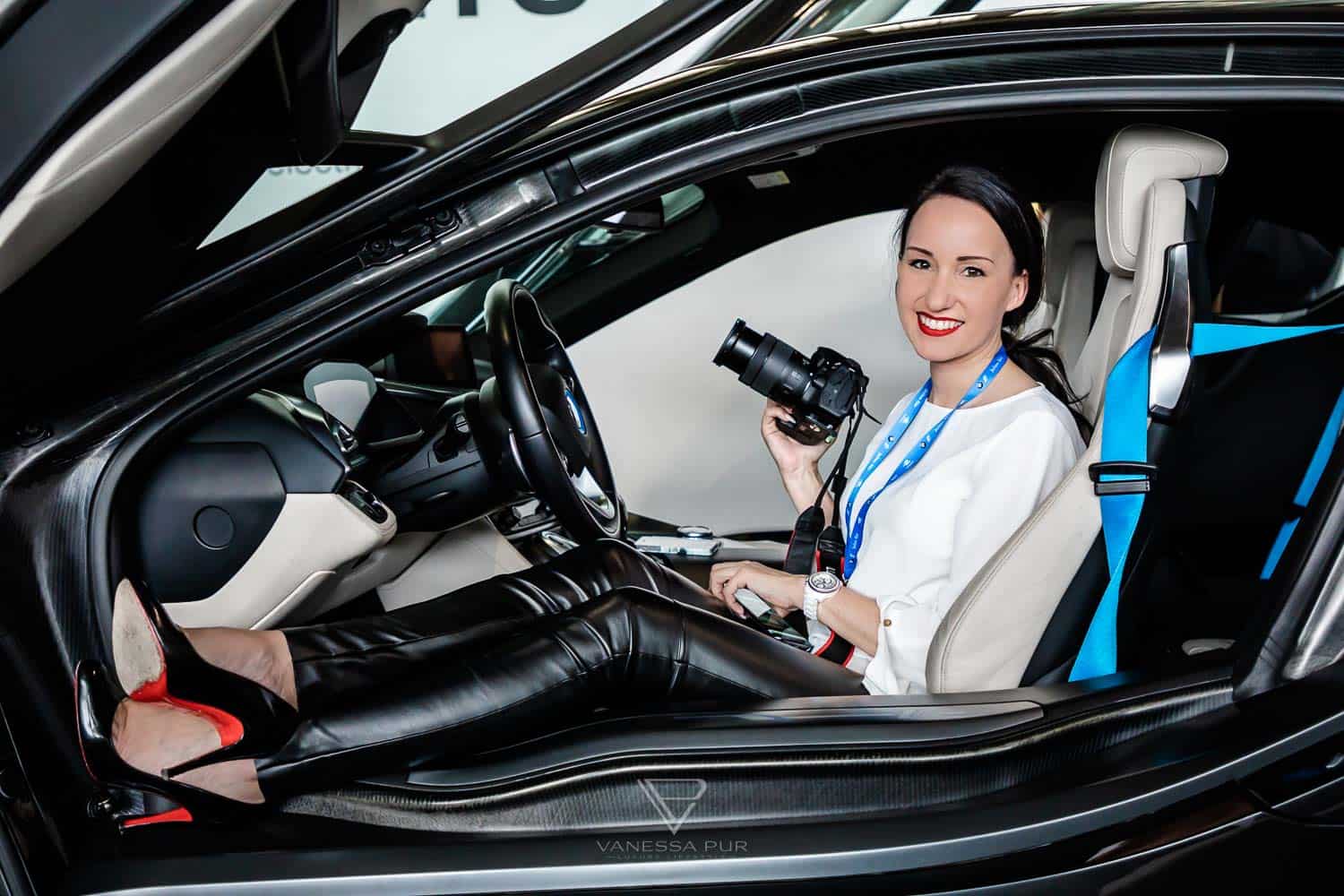 Leather Pants an white blouse with high heels in an E car, a BMW i8 at formula E Racing in Berlin
